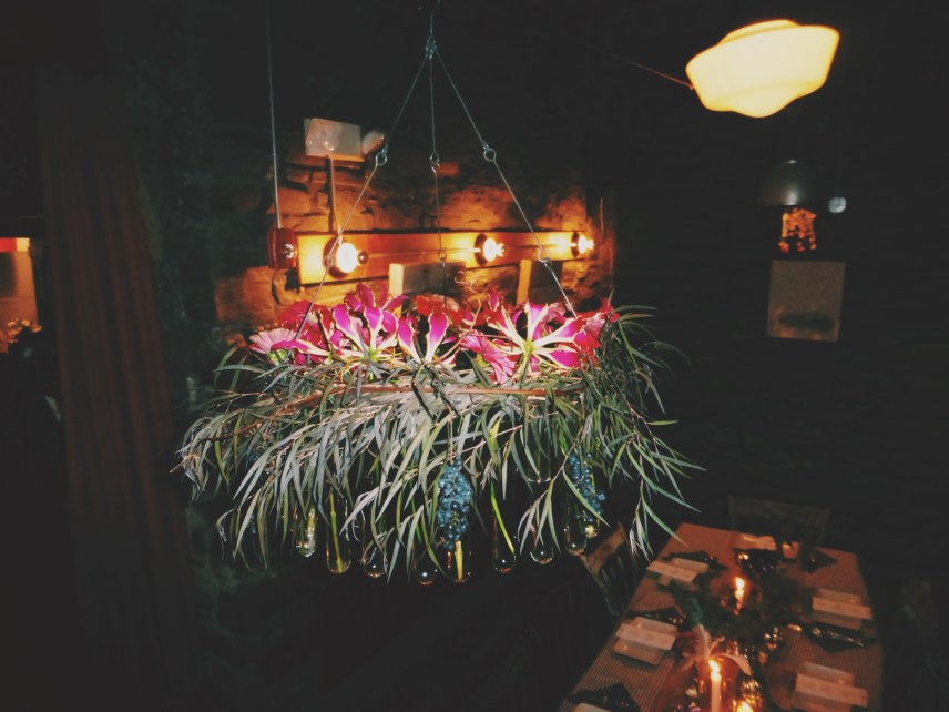 The light fixture was covered in flowers and beakers